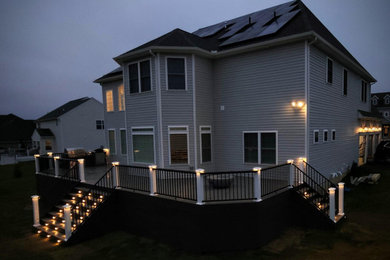Inspiration for a huge mixed material railing deck remodel in Philadelphia