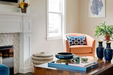 Example of a transitional living room design in Boston with beige walls, a standard fireplace, a tile fireplace and a media wall