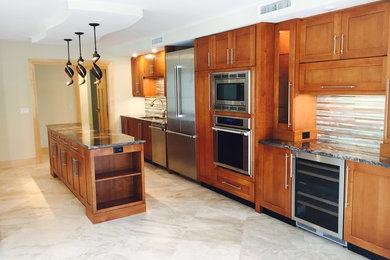 Huge arts and crafts galley marble floor eat-in kitchen photo in Miami with an undermount sink, shaker cabinets, medium tone wood cabinets, granite countertops, metallic backsplash, metal backsplash, stainless steel appliances and two islands