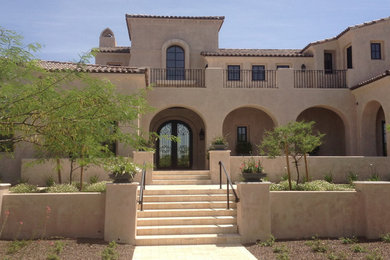 Southwest brown one-story stone house exterior photo in Phoenix with a tile roof