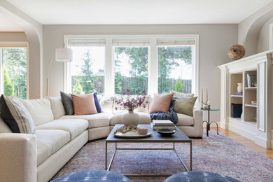 Inspiration for a contemporary light wood floor living room remodel in Portland with beige walls