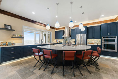 Inspiration for a large traditional u-shaped kitchen/diner in Denver with a single-bowl sink, raised-panel cabinets, blue cabinets, engineered stone countertops, multi-coloured splashback, stainless steel appliances, an island and white worktops.