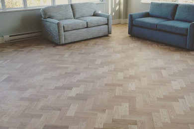 Mid-sized elegant light wood floor and brown floor living room photo in Vancouver with blue walls