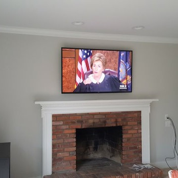 Farmington Hills TV over fireplace, with custom wall plates.