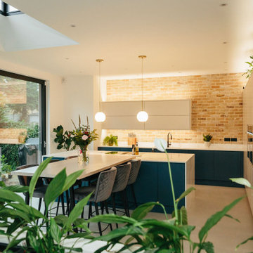 Modern traditional open plan kitchen with exposed brick