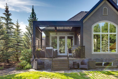 This is an example of a modern back terrace in Calgary with a pergola.