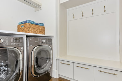 Inspiration for a large contemporary porcelain tile and brown floor laundry closet remodel with white cabinets, gray walls and white countertops
