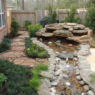 Landscaping with oversize pavers and backyard creek - hkns