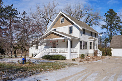 Example of an arts and crafts white two-story house exterior design in Other