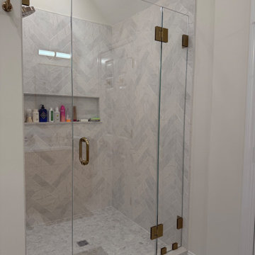 Custom Bathroom Renovation with Marble Herringbone Shower and Glass Enclosure