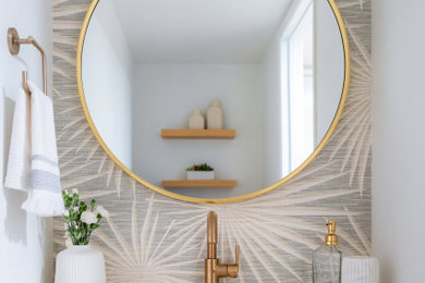 Inspiration for a small coastal wallpaper powder room remodel in San Diego with flat-panel cabinets, white walls, an integrated sink, solid surface countertops and a built-in vanity