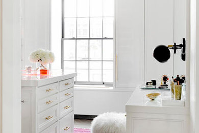 Example of a mid-sized trendy women's dressing room design in New York with white cabinets