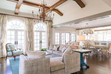 Example of a mid-sized classic open concept dark wood floor and brown floor living room design in Other with beige walls, a standard fireplace, a stone fireplace and no tv
