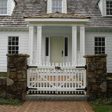 Columned Portico with White Picket Gate and Field Stone Wall