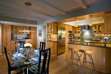 Large transitional u-shaped light wood floor eat-in kitchen photo in Orange County with a double-bowl sink, flat-panel cabinets, light wood cabinets, glass countertops, multicolored backsplash, mosaic tile backsplash, stainless steel appliances and no island