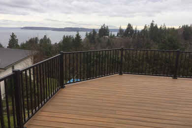 Design ideas for a large transitional backyard deck in Seattle with no cover.