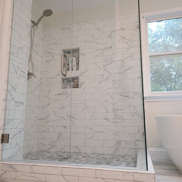 Walk-In Shower With Marble-Look Tile and Dual Niches