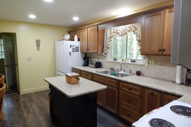 Inspiration for a small timeless l-shaped vinyl floor and brown floor enclosed kitchen remodel in Other with a drop-in sink, shaker cabinets, brown cabinets, laminate countertops, beige backsplash, terra-cotta backsplash, white appliances, an island and beige countertops