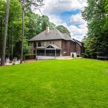 Spacious Backyard Lawn with Covered Porch and Family Play Area