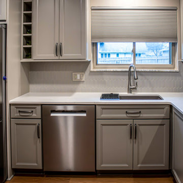 Two-Tone Neutral Kitchen with Quartz Countertop and Soho Picket Backsplash