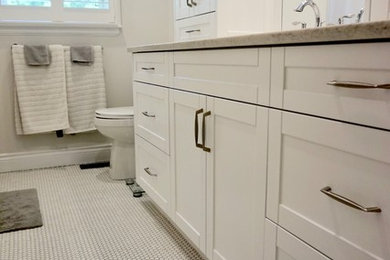 Minimalist white tile ceramic tile and white floor bathroom photo in Toronto with white cabinets, a one-piece toilet, beige walls, a console sink, granite countertops and beige countertops