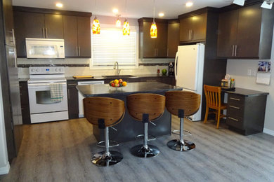 Mid-sized trendy u-shaped open concept kitchen photo in Other with a double-bowl sink, flat-panel cabinets, black cabinets, soapstone countertops, white backsplash, subway tile backsplash, white appliances and an island