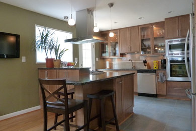 Eat-in kitchen - large transitional galley porcelain tile eat-in kitchen idea in DC Metro with an undermount sink, light wood cabinets, granite countertops, porcelain backsplash, stainless steel appliances, a peninsula, shaker cabinets and beige backsplash