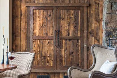 Living room - large rustic medium tone wood floor living room idea in Other with a bar and beige walls