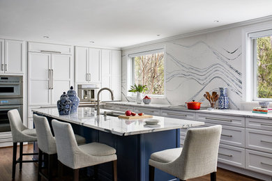 Inspiration for a large l-shaped medium tone wood floor kitchen remodel in DC Metro with an island and white countertops