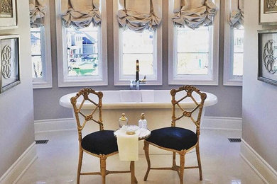 Mid-sized ornate master marble floor freestanding bathtub photo in San Diego with beige walls