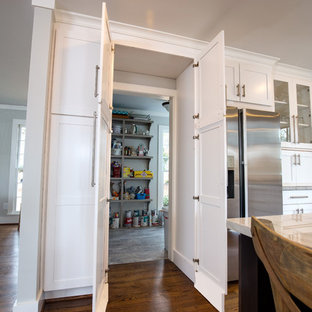 Large transitional kitchen pantry designs - Example of a large transitional u-shaped medium tone wood floor kitchen pantry design in Birmingham with white cabinets, stainless steel appliances, an island, an undermount sink, recessed-panel cabinets, quartzite countertops, beige backsplash and subway tile backsplash
