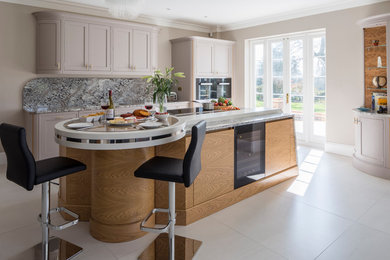 Design ideas for a large transitional open plan kitchen in Berkshire with shaker cabinets, a peninsula, medium wood cabinets, granite benchtops, stone slab splashback and porcelain floors.
