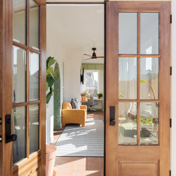Arched Built-Ins Meet Terracotta Tile in a Light-Filled Sunroom Addition