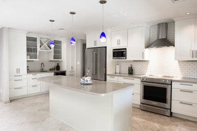 Large transitional travertine floor and beige floor eat-in kitchen photo in Phoenix with an undermount sink, shaker cabinets, white cabinets, quartz countertops, beige backsplash, subway tile backsplash, stainless steel appliances and an island