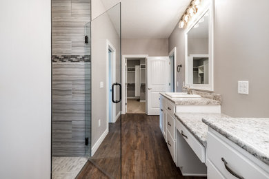 Transitional master vinyl floor and brown floor walk-in shower photo in Other with shaker cabinets, white cabinets, gray walls, a drop-in sink, laminate countertops and a hinged shower door