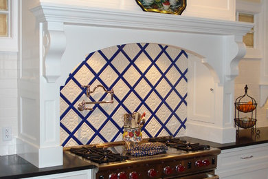 Eat-in kitchen - large traditional medium tone wood floor eat-in kitchen idea in Little Rock with shaker cabinets, white cabinets, granite countertops, multicolored backsplash, ceramic backsplash and stainless steel appliances