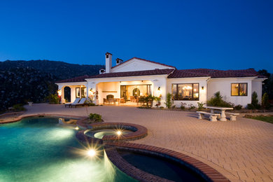 Inspiration for a mediterranean white one-story exterior home remodel in San Diego