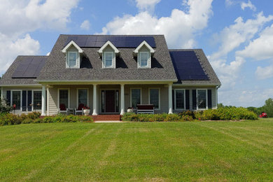 Example of a mid-sized country gray two-story house exterior design in Kansas City with a shingle roof