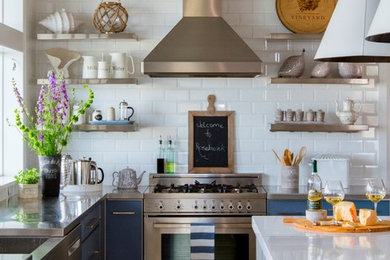 Kitchen - coastal l-shaped light wood floor kitchen idea in Jacksonville with stainless steel countertops, white backsplash, subway tile backsplash, stainless steel appliances, an island, open cabinets and stainless steel cabinets