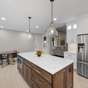 Large Two-Tone Kitchen Island with Quartz Countertop and Modern Pendant Lighting