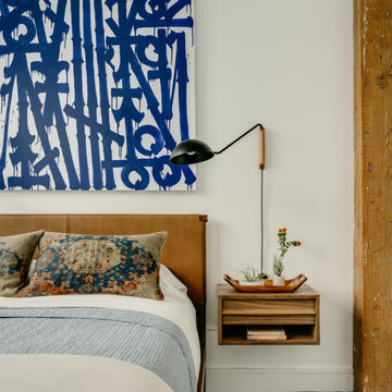 White Loft Bedroom with Leather Headboard, Graffiti Art, Floating Nightstand