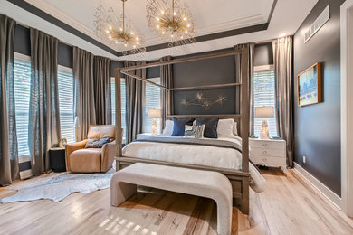 Large transitional master light wood floor bedroom photo in Kansas City with gray walls