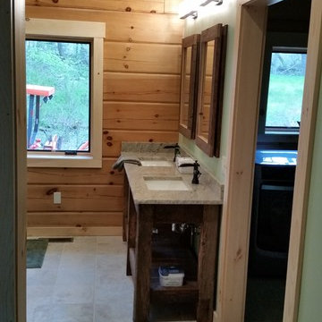 Rustic reclaimed wood vanity with a granite countertop with a chiseled edge