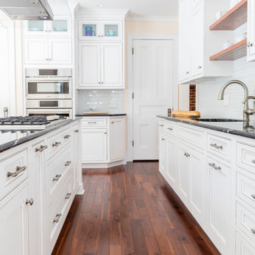 Black and White Kitchen with Banquette, Bar, and Desk