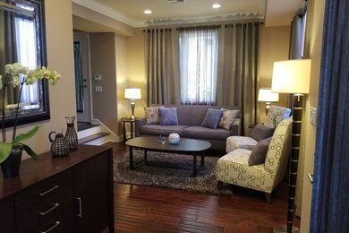 Example of a small trendy formal and open concept dark wood floor and brown floor living room design in Los Angeles with beige walls, no fireplace and a tv stand