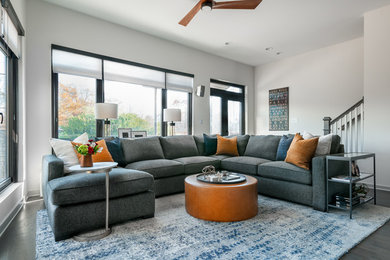 Living room - large contemporary formal and open concept medium tone wood floor and brown floor living room idea in Atlanta with white walls and a wall-mounted tv