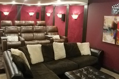 Example of a large transitional enclosed carpeted and black floor home theater design in Cincinnati with red walls and a projector screen