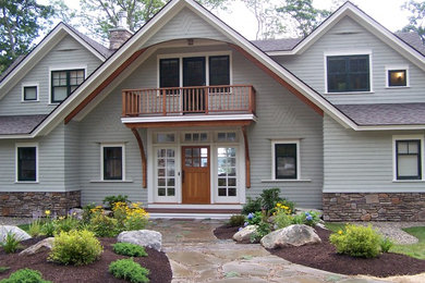 Large traditional two-story wood gable roof idea in Portland Maine