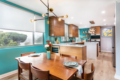 Inspiration for a small mid-century modern galley laminate floor eat-in kitchen remodel in Los Angeles with an undermount sink, flat-panel cabinets, medium tone wood cabinets, quartz countertops, blue backsplash, stainless steel appliances, an island and white countertops