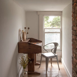 Photo of a small eclectic study room in Columbus with beige walls, plywood floors and a freestanding desk.